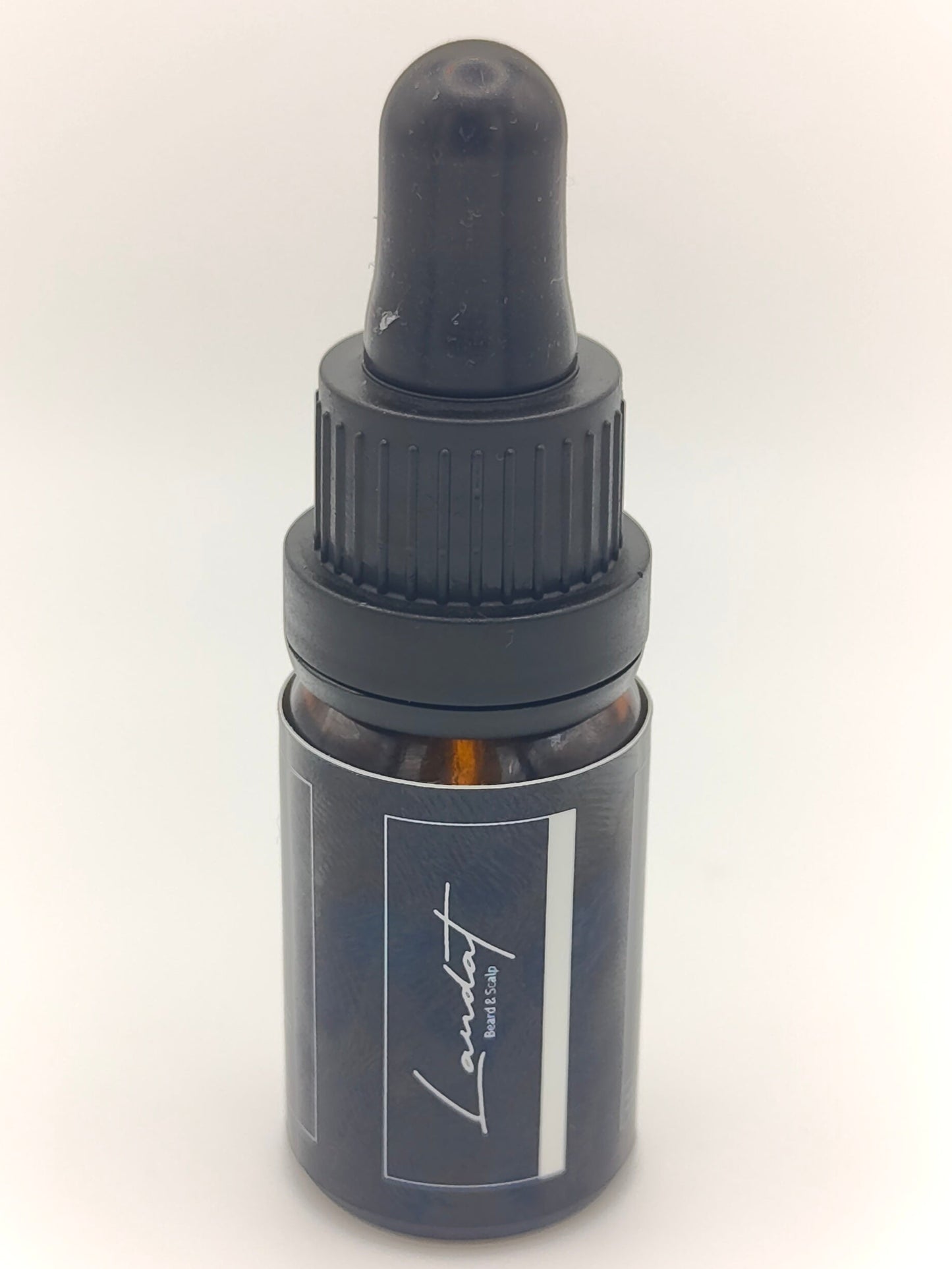 Black dropper bottle with a visible brand logo on a white background