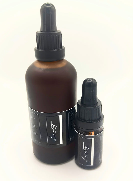 Two brown glass bottles with black droppers on a white background